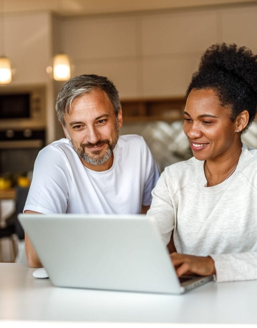 Two adults using modern technology, searching something online.